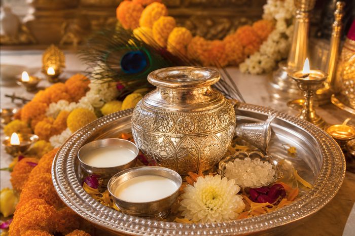 Silver Kalash Abhishek — silver kalash with milk, sugar crystals and peacock feather on a puja thali